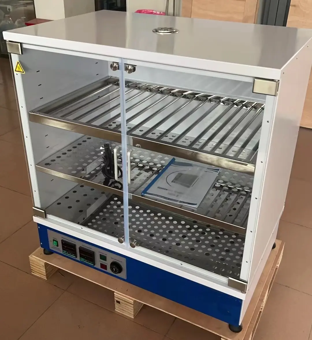 Laboratory glassware drying cabinet interior with rod and perforated shelf arrangements