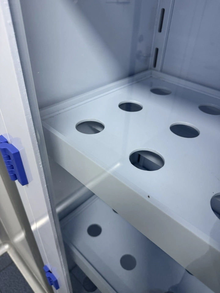 Perforated adjustable shelf inside a PP laboratory glassware cabinet